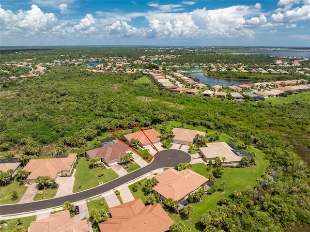 birds eye view of property with a water view