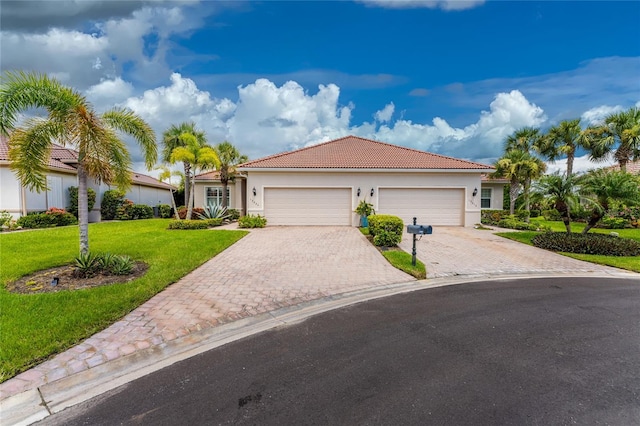 view of front of property with a garage and a front yard