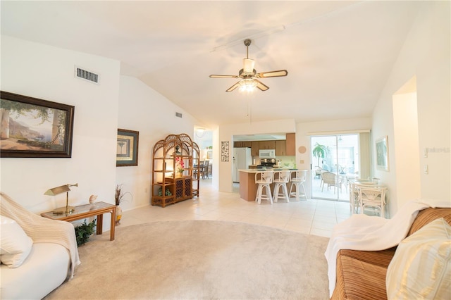 tiled living room with ceiling fan and vaulted ceiling