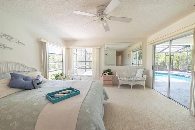 bedroom featuring ceiling fan, carpet, a textured ceiling, and access to outside