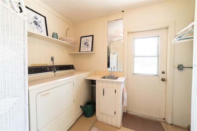 washroom with sink and washer and dryer