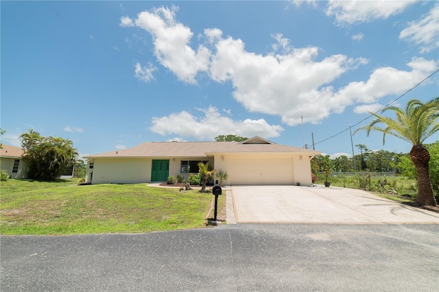 single story home featuring a garage and a front yard