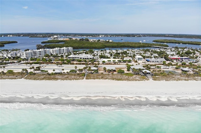 birds eye view of property with a water view and a beach view