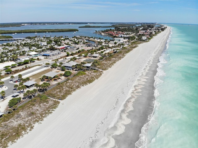 drone / aerial view with a water view and a beach view