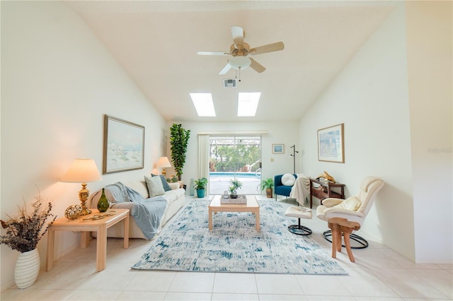 3440 Downing St W, Englewood, FL 34224 - tiled living room featuring lofted ceiling, a skylight, ceiling fan, and baseboards