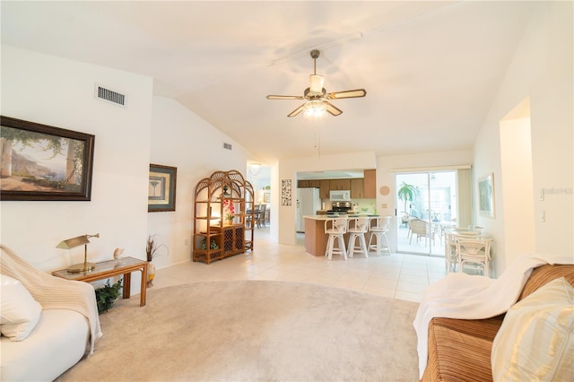 3440 Downing St W, Englewood, FL 34224 - living room with light tile patterned flooring, a ceiling fan, lofted ceiling, baseboards, and light colored carpet