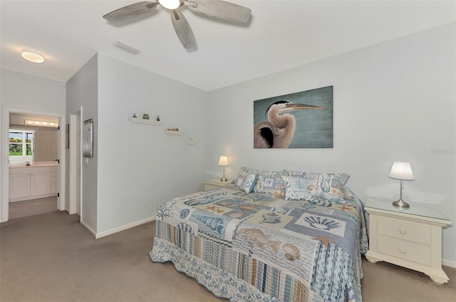 carpeted bedroom featuring ceiling fan, ensuite bath, and sink