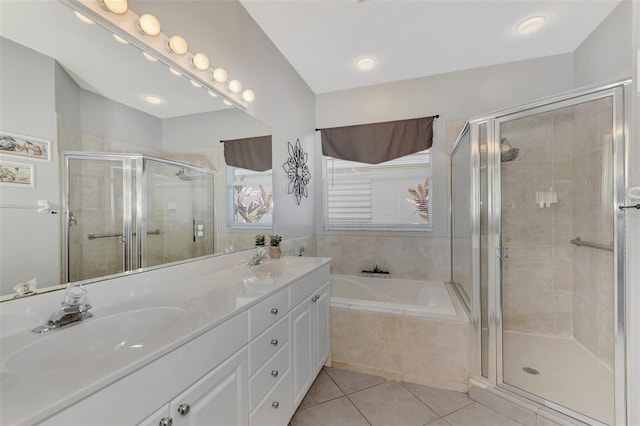 bathroom with independent shower and bath, tile patterned floors, and vanity