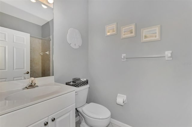 bathroom with tile patterned floors, toilet, tiled shower, and vanity