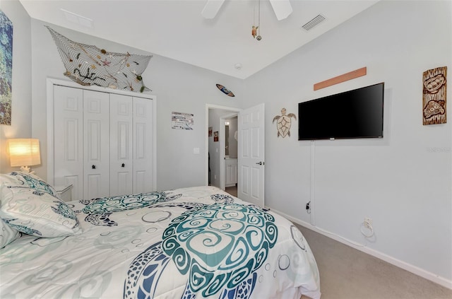 carpeted bedroom with lofted ceiling, ceiling fan, and a closet