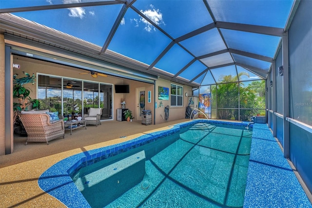 view of pool with an outdoor hangout area, ceiling fan, glass enclosure, and a patio