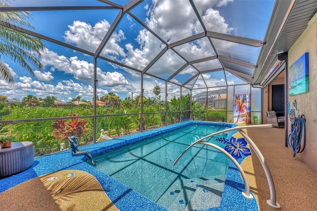 view of pool with glass enclosure