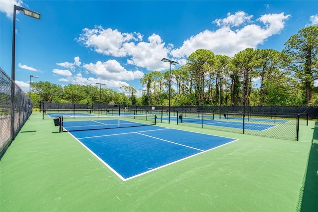 view of tennis court featuring basketball hoop