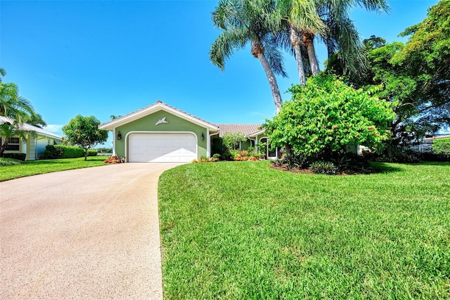 view of front of home with a front yard and a garage