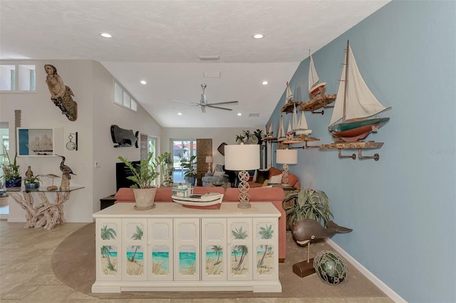 interior space with ceiling fan and vaulted ceiling