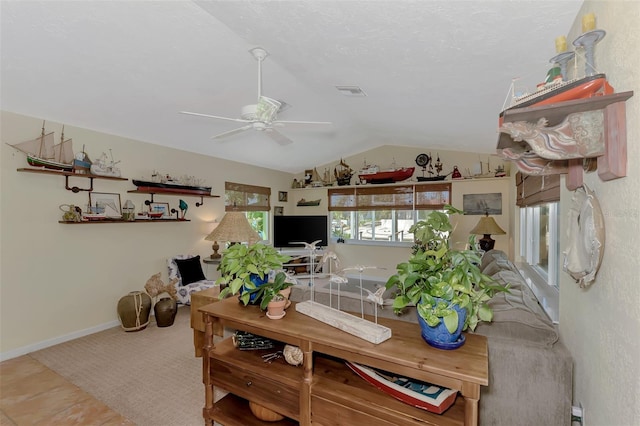 living room with vaulted ceiling, ceiling fan, and tile patterned flooring