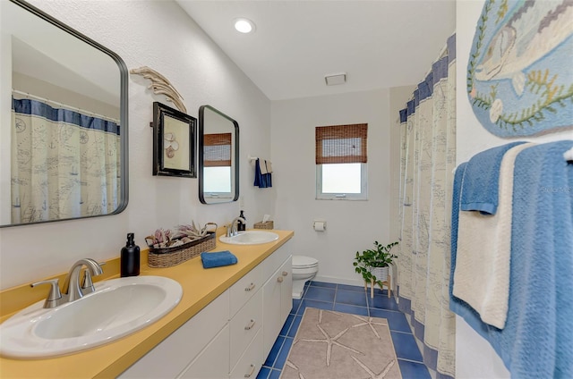 bathroom featuring toilet, vanity, and tile patterned floors