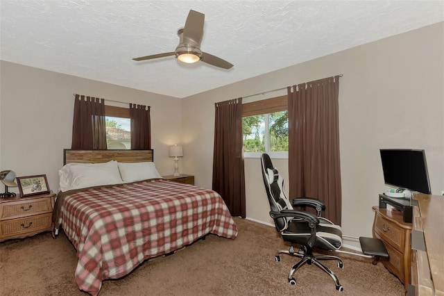 bedroom with ceiling fan, multiple windows, and light carpet