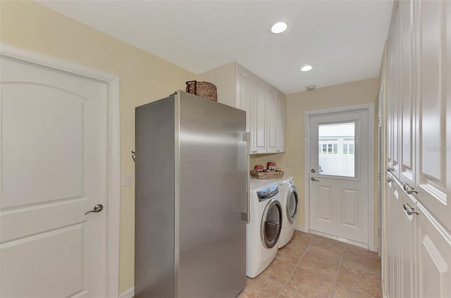 washroom featuring washer and clothes dryer and cabinets