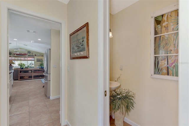 corridor featuring vaulted ceiling and sink