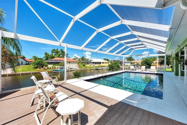 view of pool with a lanai and a deck with water view