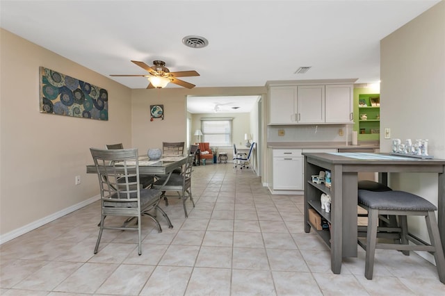 tiled dining room with ceiling fan