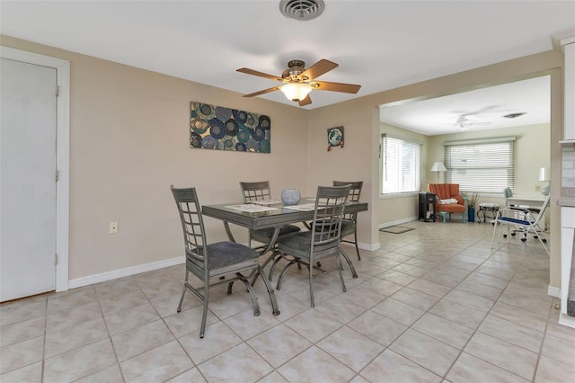 dining room with ceiling fan and light tile patterned floors