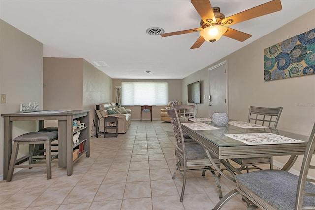 tiled dining space featuring ceiling fan