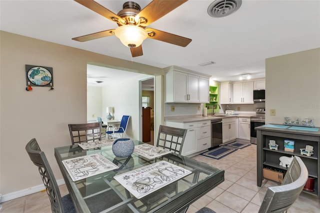 tiled dining space with sink and ceiling fan