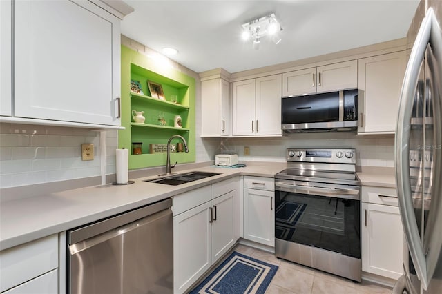 kitchen with tasteful backsplash, sink, light tile patterned flooring, and appliances with stainless steel finishes