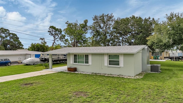 view of property exterior with a yard and central AC