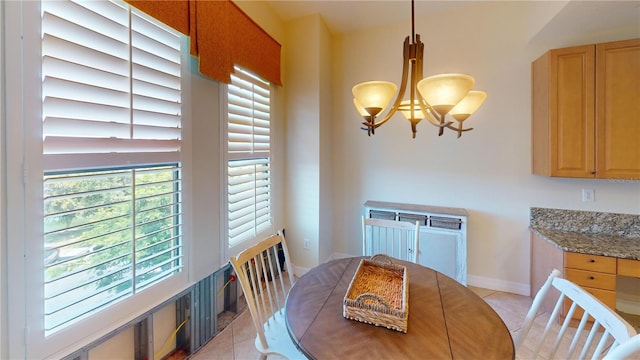 dining space featuring a notable chandelier, a wealth of natural light, and light tile patterned floors