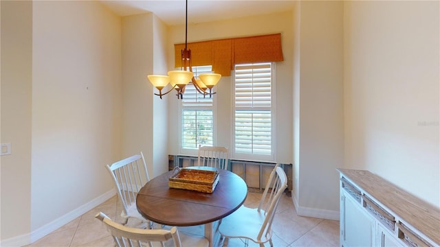 tiled dining area featuring a notable chandelier