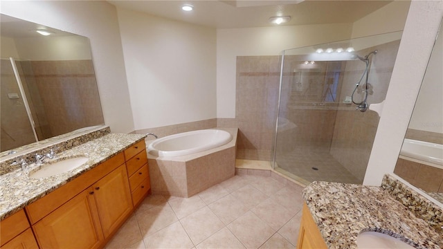 bathroom featuring independent shower and bath, tile patterned floors, and vanity