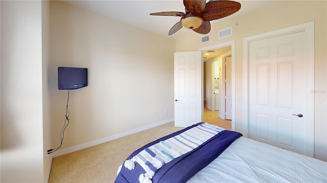 bedroom with light colored carpet and ceiling fan