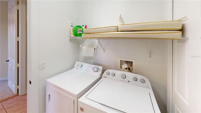 washroom featuring light tile patterned flooring and washer and clothes dryer