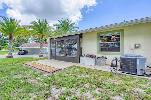 back of house featuring a patio area, central AC unit, and a lawn