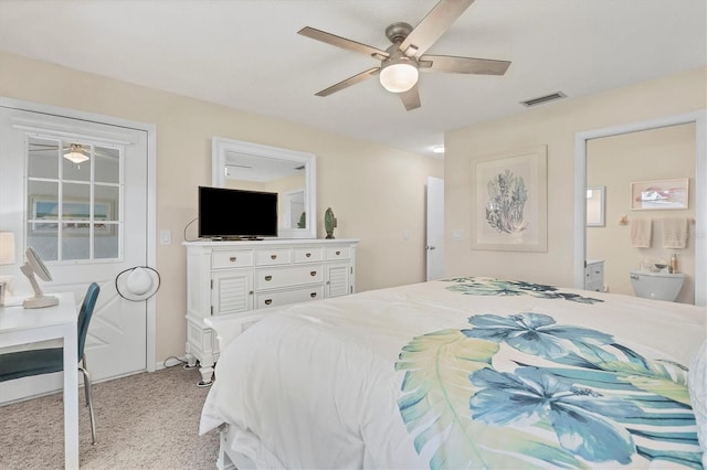 bedroom featuring ceiling fan, light colored carpet, and ensuite bathroom