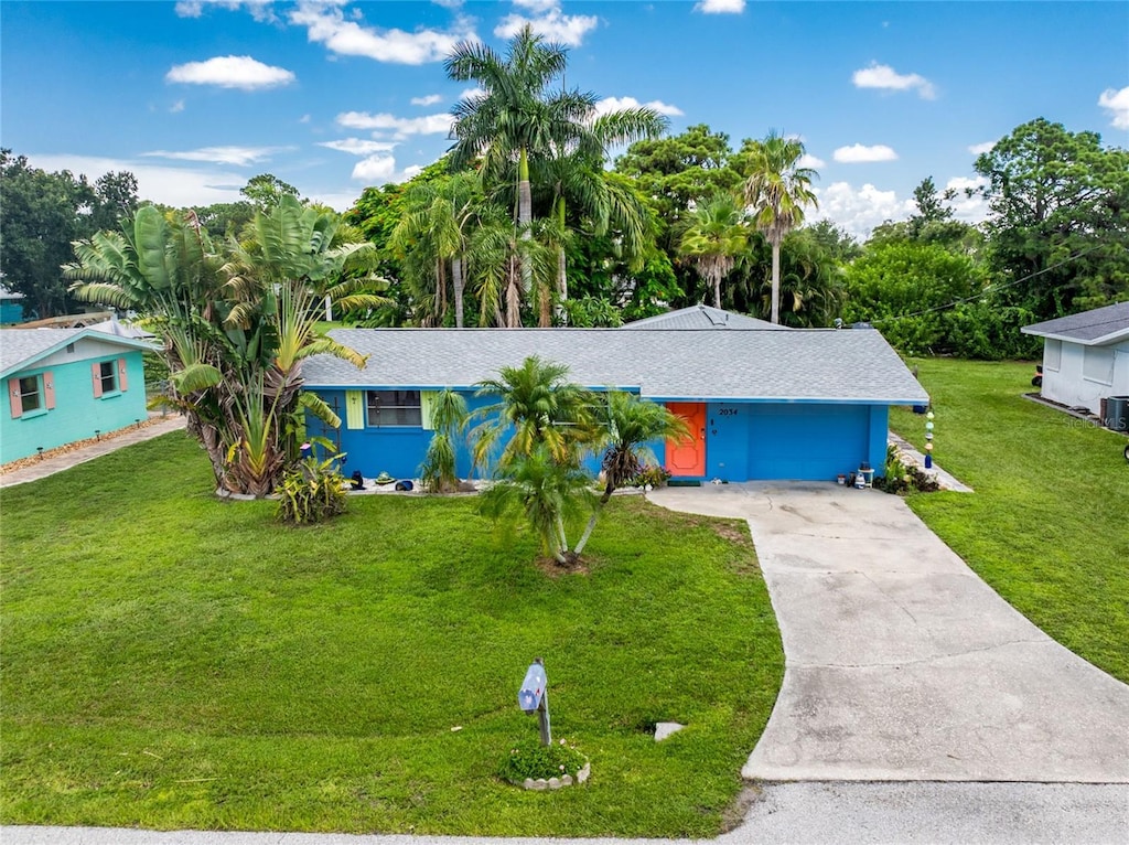 single story home featuring a garage and a front yard