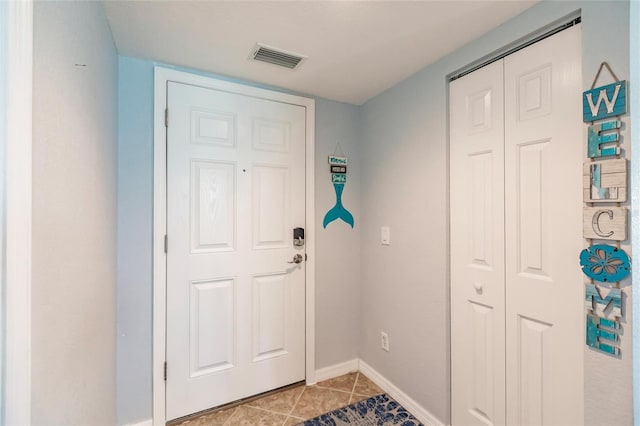 doorway with light tile patterned floors