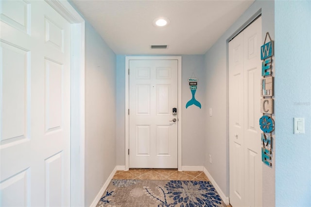 doorway to outside featuring light tile patterned floors