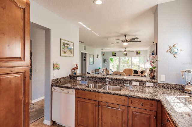 kitchen featuring light tile patterned flooring, kitchen peninsula, dishwasher, ceiling fan, and sink