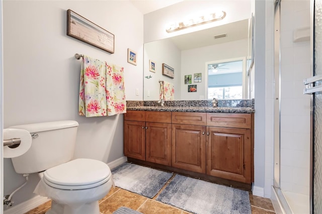 bathroom with a shower with shower door, toilet, vanity, ceiling fan, and tile patterned floors