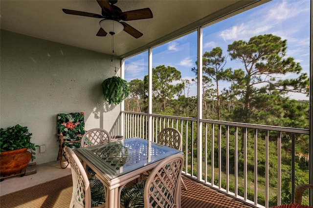 sunroom featuring ceiling fan