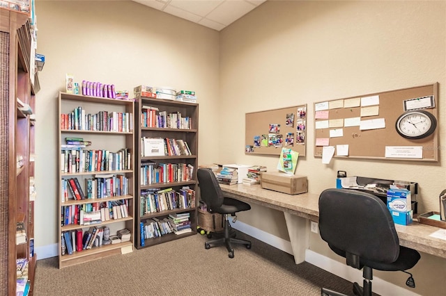 home office featuring carpet flooring and a paneled ceiling