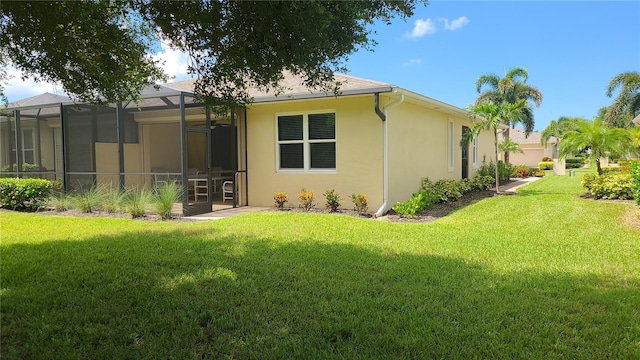 back of house featuring a yard and a lanai