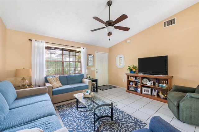 living room featuring lofted ceiling, light tile patterned floors, and ceiling fan