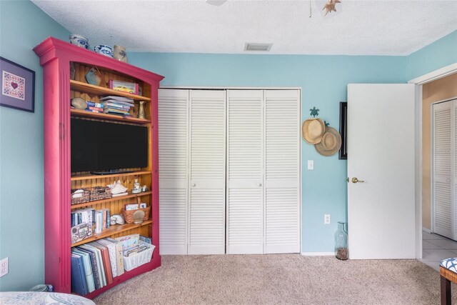 playroom featuring carpet and a textured ceiling