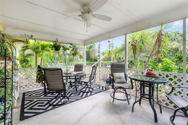 sunroom featuring ceiling fan