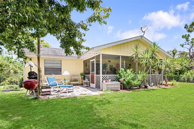 rear view of property featuring a patio and a yard